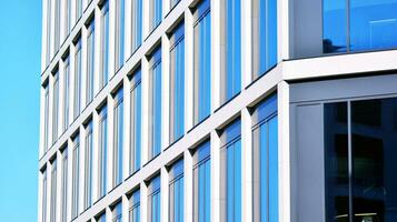 Modern office building with glass facade on a clear sky background. Transparent glass wall of office building. photo