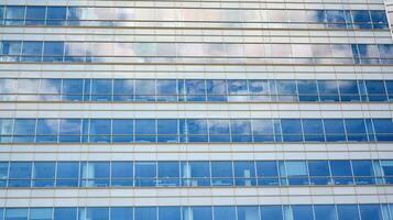 Glass building with transparent facade of the building and blue sky. Structural glass wall reflecting blue sky. Abstract modern architecture fragment. Contemporary architectural background. photo