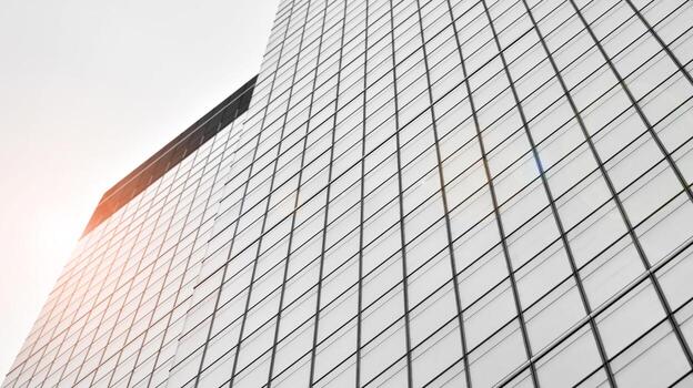Glass modern building with blue sky background. View and architecture details. Urban abstract - windows of glass office building in  sunlight day. Black and white. photo