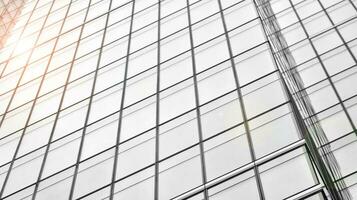 Glass modern building with blue sky background. View and architecture details. Urban abstract - windows of glass office building in  sunlight day. Black and white. photo