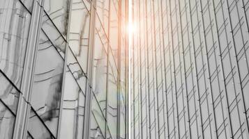 Glass modern building with blue sky background. View and architecture details. Urban abstract - windows of glass office building in  sunlight day. Black and white. photo