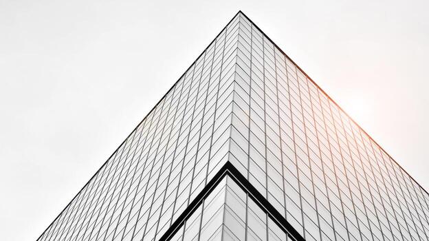Glass modern building with blue sky background. View and architecture details. Urban abstract - windows of glass office building in  sunlight day. Black and white. photo