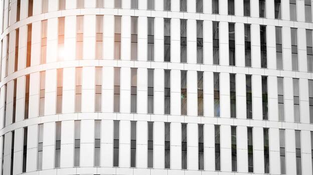 Glass modern building with blue sky background. View and architecture details. Urban abstract - windows of glass office building in  sunlight day. Black and white. photo