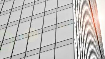 Glass modern building with blue sky background. View and architecture details. Urban abstract - windows of glass office building in  sunlight day. Black and white. photo