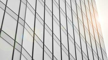 Glass modern building with blue sky background. View and architecture details. Urban abstract - windows of glass office building in  sunlight day. Black and white. photo