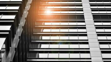 Glass modern building with blue sky background. View and architecture details. Urban abstract - windows of glass office building in  sunlight day. Black and white. photo