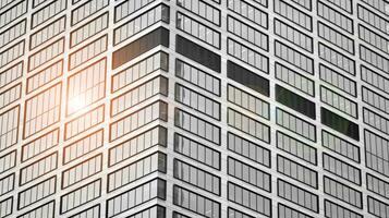 Glass modern building with blue sky background. View and architecture details. Urban abstract - windows of glass office building in  sunlight day. Black and white. photo