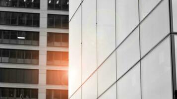 Glass modern building with blue sky background. View and architecture details. Urban abstract - windows of glass office building in  sunlight day. Black and white. photo