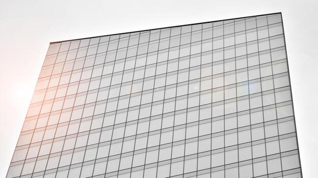 Glass modern building with blue sky background. View and architecture details. Urban abstract - windows of glass office building in  sunlight day. Black and white. photo