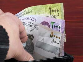 Syrian money in the black wallet photo