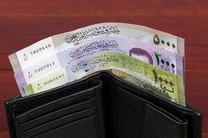 Syrian money in the black wallet photo