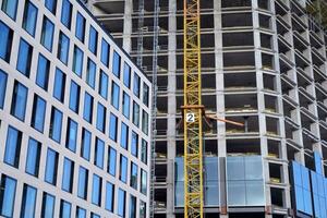 View of a skyscraper under construction. Modern architecture background. Building a high-rise building,  the concept of real estate construction. photo