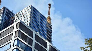 View of a skyscraper under construction. Modern architecture background. Building a high-rise building,  the concept of real estate construction. photo