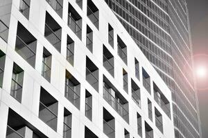 Modern apartment building in sunny day. Exterior, residential house facade. Black and white. photo