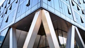 Combination of metal and glass wall material. Steel facade on columns. Abstract modern architecture. High-tech minimalist office building. Contemporary business architecture abstract fragment. photo
