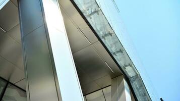 Combination of metal and glass wall material. Steel facade on columns. Abstract modern architecture. High-tech minimalist office building. Contemporary business architecture abstract fragment. photo
