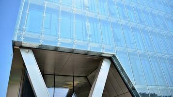 Combination of metal and glass wall material. Steel facade on columns. Abstract modern architecture. High-tech minimalist office building. Contemporary business architecture abstract fragment. photo