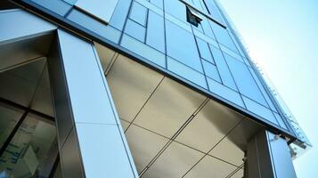 Combination of metal and glass wall material. Steel facade on columns. Abstract modern architecture. High-tech minimalist office building. Contemporary business architecture abstract fragment. photo