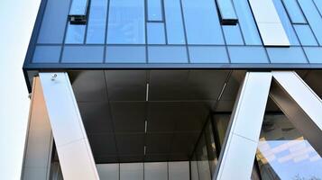 Combination of metal and glass wall material. Steel facade on columns. Abstract modern architecture. High-tech minimalist office building. Contemporary business architecture abstract fragment. photo