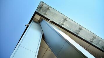 Combination of metal and glass wall material. Steel facade on columns. Abstract modern architecture. High-tech minimalist office building. Contemporary business architecture abstract fragment. photo