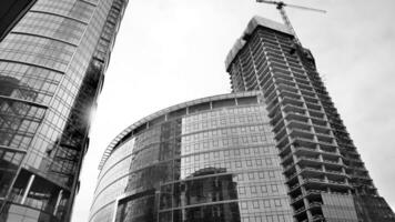 View of a skyscraper under construction. Modern architecture background. Building a high-rise building,  the concept of real estate construction. Black and white. photo