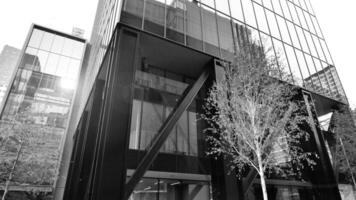 Combination of metal and glass wall material. Steel facade on columns. Abstract modern architecture. High-tech minimalist office building. Black and white. photo