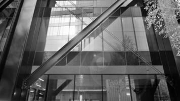 Combination of metal and glass wall material. Steel facade on columns. Abstract modern architecture. High-tech minimalist office building. Black and white. photo