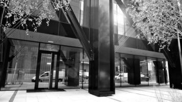 Combination of metal and glass wall material. Steel facade on columns. Abstract modern architecture. High-tech minimalist office building. Black and white. photo