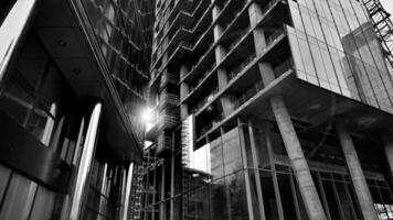 Combination of metal and glass wall material. Steel facade on columns. Abstract modern architecture. High-tech minimalist office building. Black and white. photo
