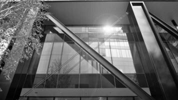 Combination of metal and glass wall material. Steel facade on columns. Abstract modern architecture. High-tech minimalist office building. Black and white. photo