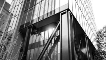 Combination of metal and glass wall material. Steel facade on columns. Abstract modern architecture. High-tech minimalist office building. Black and white. photo
