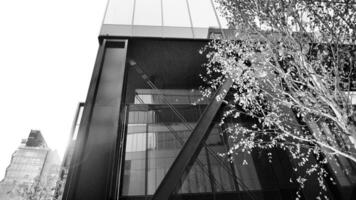 Combination of metal and glass wall material. Steel facade on columns. Abstract modern architecture. High-tech minimalist office building. Black and white. photo