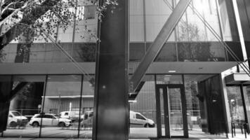 Combination of metal and glass wall material. Steel facade on columns. Abstract modern architecture. High-tech minimalist office building. Black and white. photo