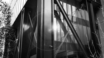 Combination of metal and glass wall material. Steel facade on columns. Abstract modern architecture. High-tech minimalist office building. Black and white. photo