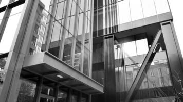 Combination of metal and glass wall material. Steel facade on columns. Abstract modern architecture. High-tech minimalist office building. Black and white. photo