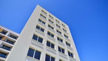 Brand new apartment building on sunny day. Modern residential architecture. Modern multi-family apartment house. photo