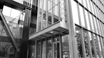 Combination of metal and glass wall material. Steel facade on columns. Abstract modern architecture. High-tech minimalist office building. Black and white. photo
