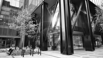 Combination of metal and glass wall material. Steel facade on columns. Abstract modern architecture. High-tech minimalist office building. Black and white. photo