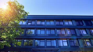 Structural glass wall reflecting blue sky. Abstract modern architecture fragment. Glass building with transparent facade of the building and blue sky. Contemporary architectural background. photo