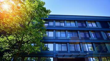 Structural glass wall reflecting blue sky. Abstract modern architecture fragment. Glass building with transparent facade of the building and blue sky. Contemporary architectural background. photo