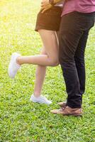 Body part. Couple standing in park. They are kiss and hug.concept for love. photo