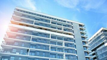 Modern luxury residential flat. Modern apartment building on a sunny day. Apartment building with a blue sky. Facade of a modern apartment building. photo
