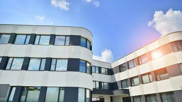 Office building with white aluminum composite panels. Facade wall made of glass and metal. Abstract modern business architecture. photo