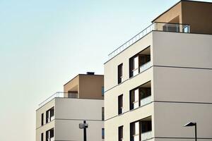 Modern apartment buildings on a sunny day with a blue sky. Facade of a modern apartment building photo