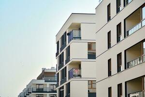 Modern apartment buildings on a sunny day with a blue sky. Facade of a modern apartment building photo