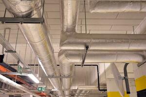 Sanitary system pipes and electrical cables installed under flat slab reinforced concrete structure in building. photo