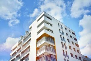 Modern apartment buildings on a sunny day with a blue sky. Facade of a modern apartment building photo