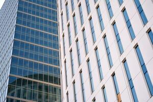 Modern office building in the city with windows and  steel and aluminum panels wall. Contemporary commercial architecture, vertical converging geometric lines. photo