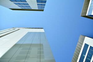 Modern office building in the city with windows and  steel and aluminum panels wall. Contemporary commercial architecture, vertical converging geometric lines. photo