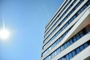 Modern office building in the city with windows and  steel and aluminum panels wall. Contemporary commercial architecture, vertical converging geometric lines. photo